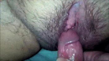 He rubs his cock on her hairy pussy